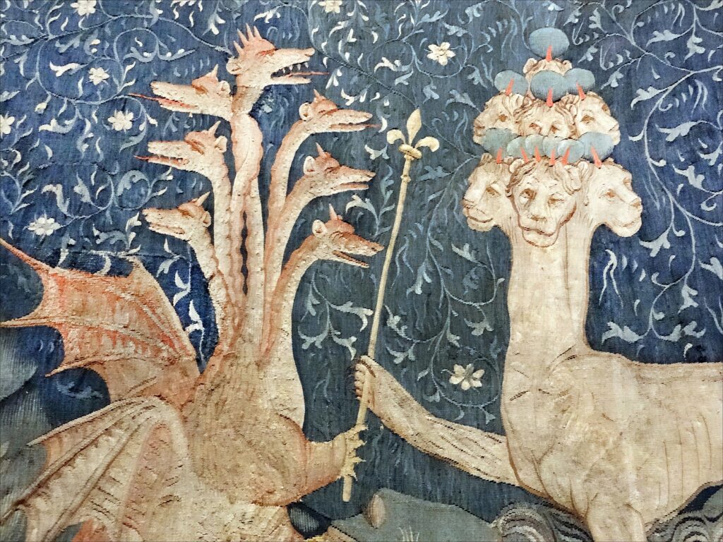 Image of the medieval French Apocalypse Tapestry, produced between 1377 and 1382. Satan (the dragon; on the left) gives to the beast of the sea (on the right) power represented by a sceptre in a detail of panel III.